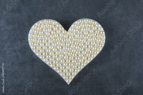 Valentine’s day background with heart of pearls and gray background.