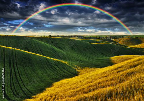 Scenic view of rainbow over green field