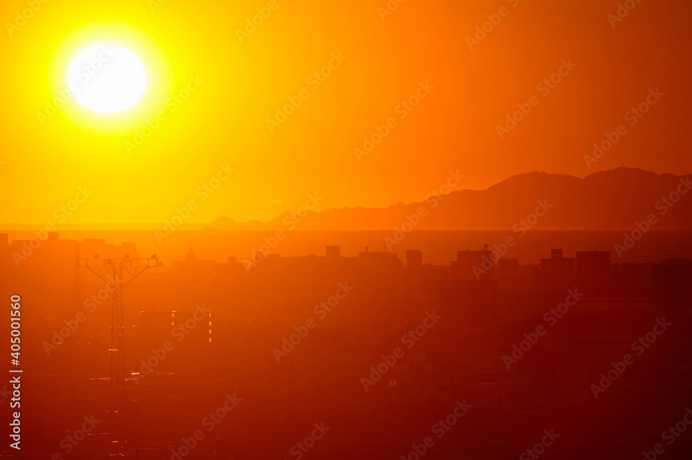 A sunset view of Mishima City and Surugu Bay in Shizuoka Prefecture in Japan at sunset. A sunset view of Mishima City and Surugu Bay in Shizuoka Prefecture in Japan at sunset.