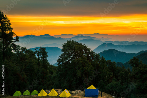 Camping in the mountains. Scenic golden hues of Sunset in the mountains of Himalaya in a small village,  Lohajung, Uttarakhand, India. photo