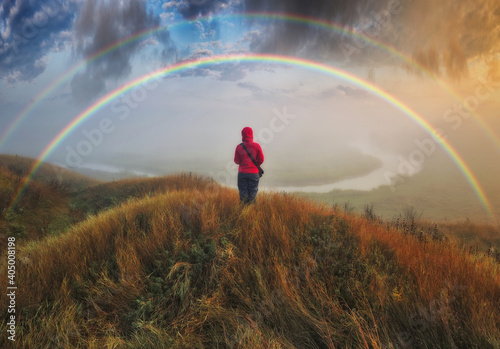 Woman Looking At Rainbow. rainbow over the autumn river