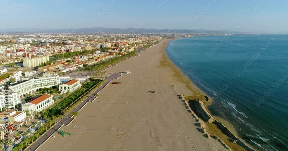 Beach of Valencia in Spain. We can see the beautiful city and the Mediterranean Sea all over the horizon from the beach 4K Beach of Valencia in Spain. We can see the beautiful city and the Mediterranean Sea all over the horizon from the beach 4K