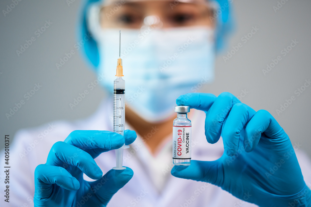 doctor holding Coronavirus (Covid-19) vaccine bottle and syringe injection medicine doctor holding Coronavirus (Covid-19) vaccine bottle and syringe injection medicine