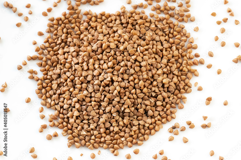 Buckwheat grains. Pile of buckwheat isolated on white background. Top view. The concept of diet and healthy eating, the background texture of the buckwheat. Buckwheat. Grain culture Buckwheat grains. Pile of buckwheat isolated on white background. Top view. The concept of diet and healthy eating, the background texture of the buckwheat. Buckwheat. Grain culture