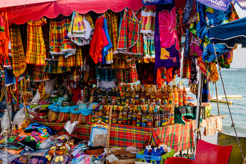 Guadelope, France - February 10, 2020: Typical tourist market in Guadeloupe selling tradicional beverages, spices and other itens. © EPasqualli