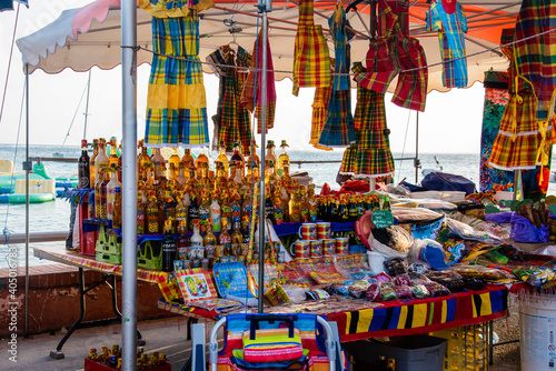 Typical tourist market in Guadeloupe selling traditional beverages, spices and other itens.