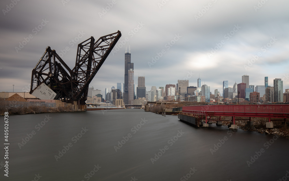 Chicago, Illinois, USA: Chicago skyline with St. Charles Air Line Bridge. View from Ping Tom memorial park. Long exposure.