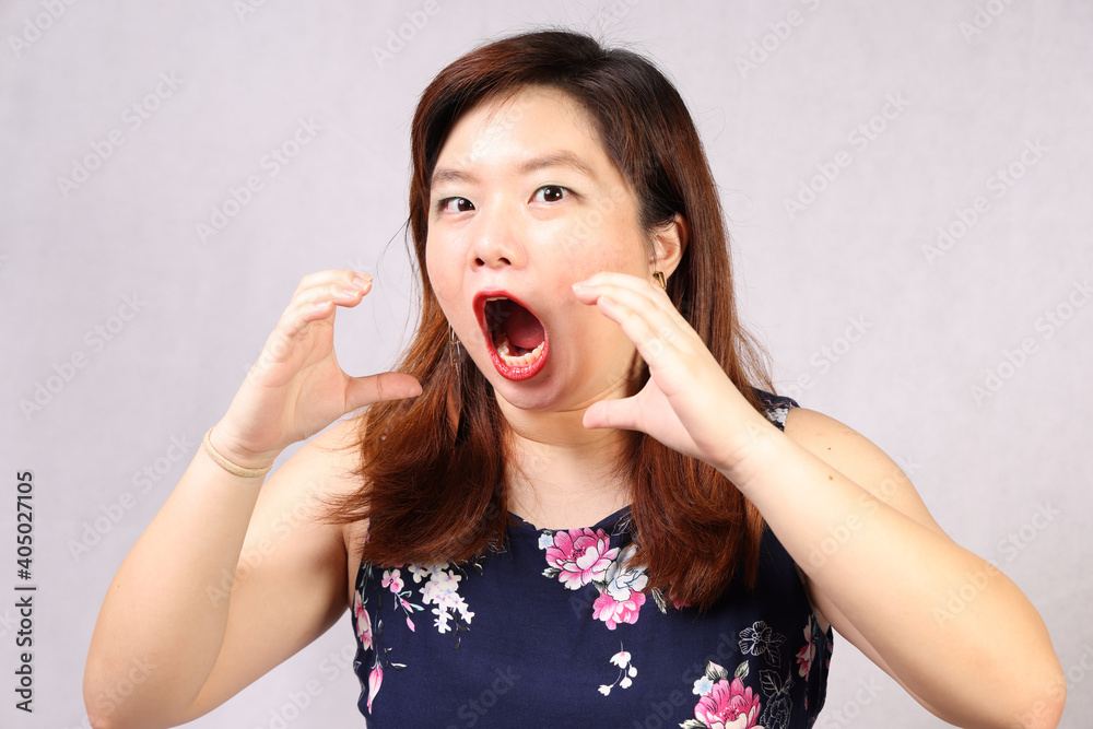 Fototapeta premium Young attractive southeast Asian woman posing facial expression eat hungry