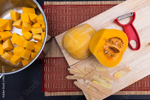 peeling and cutting squash on board for soup