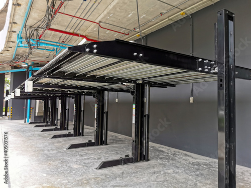 Automatic Elevator double stack car park. Hydraulic lift. Empty garage. Hydraulic machine for lifting car outdoor parking.