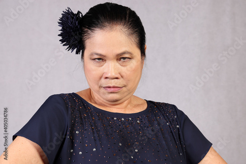Elderly senor Asian woman posing facial expression angry look © oqba