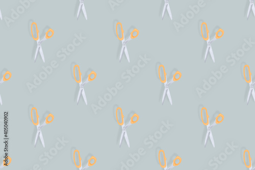 Scissors seamless pattern. Barber scissors against gray background backdrop. © Zuev Ali
