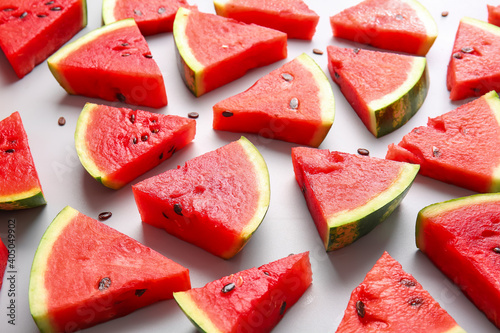 Slices of ripe watermelon on light background