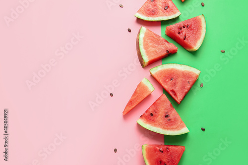 Slices of ripe watermelon on color background