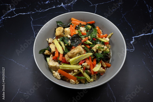 Fried and stirred mixed vegetable, chilly and tofu serving on the plate. Famous vegetarian menu in Asia restaurant. 