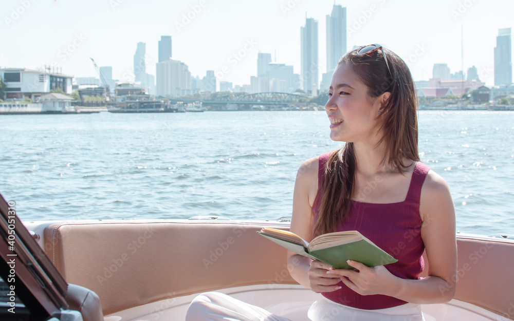 Woman reading book while sitting on boat Woman reading book while sitting on boat