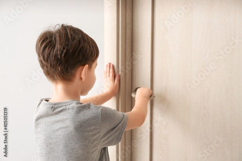 Little boy standing near cl...