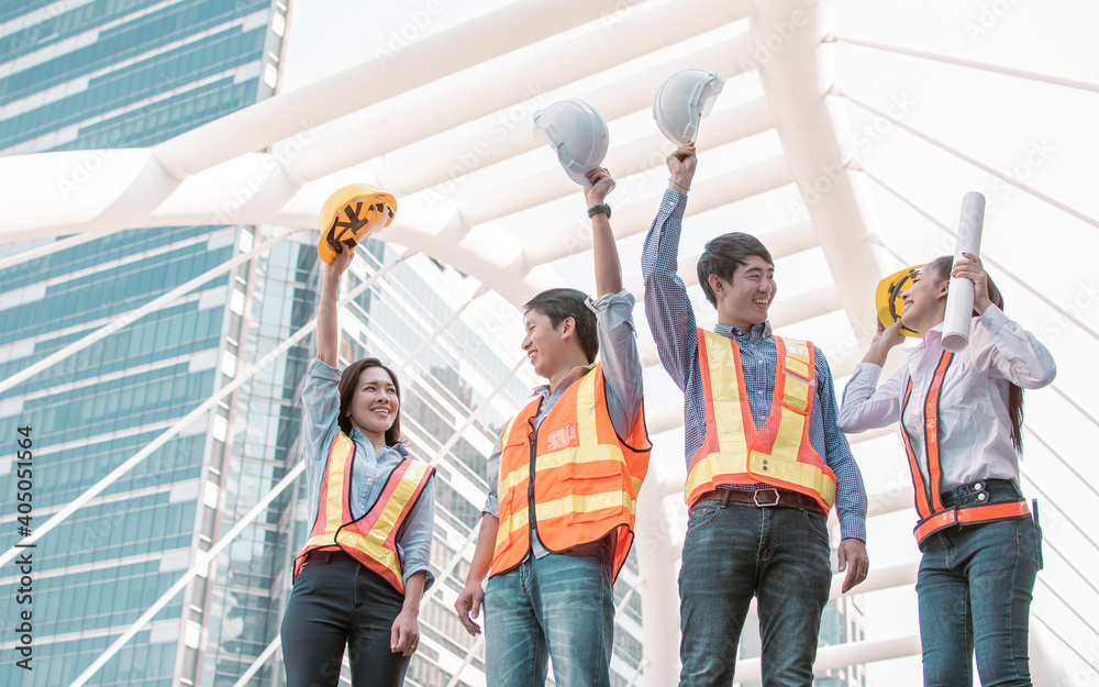 Obraz premium Portrait of engineering group standing near buildings. Construction Concept.