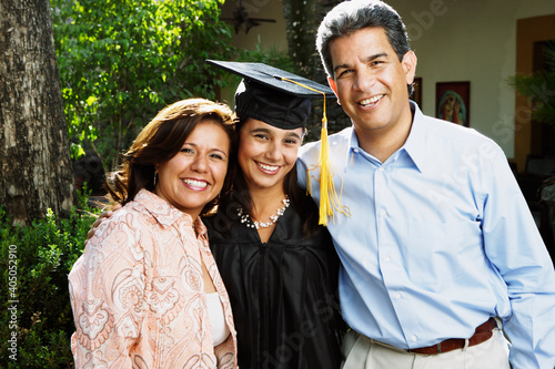 Graduate and parents smiling for the camera photo