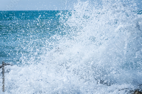 Close-up of sea waves breaking on the rocks of Vilanova y la Geltru beach