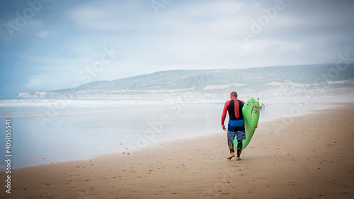 Canvas Print Man with surfboard at the beach, Morocco