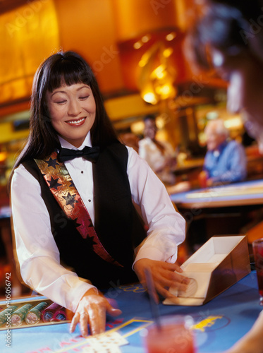 Woman dealing cards at casino photo