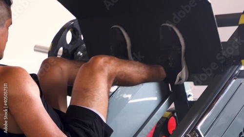 closeup of a man's feet doing an incline leg press exercise