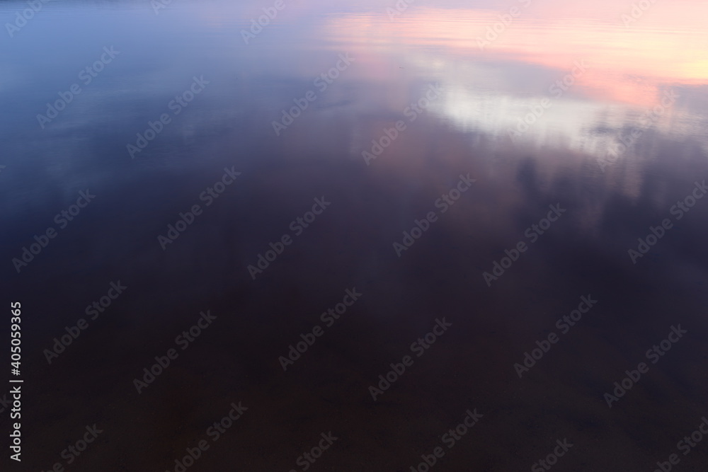 Lake water with light reflection at sunset