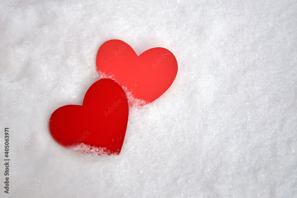 Two paper hearts in the snow. A symbol of mutual love. Valentine's Day. love in a person's life