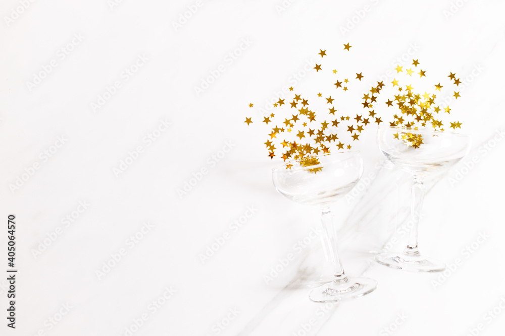 celebration background with glass of golden glitters, Top view. celebration background with glass of golden glitters, Top view.