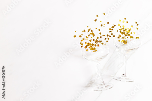celebration background with glass of golden glitters, Top view.