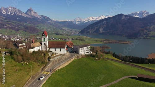 Aerial footage of the idyllic Steinerberg village on the road between Arth and Schwyz with the Lauerzersee lake and the 
Grosser Mythen mountain peak in the background in Central Switzerland. photo