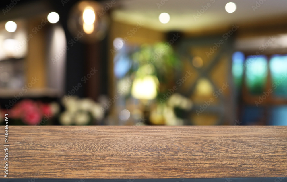 Empty wooden table in front of abstract blurred background of coffee shop . can be used for display or montage your products.Mock up for display of product Empty wooden table in front of abstract blurred background of coffee shop . can be used for display or montage your products.Mock up for display of product