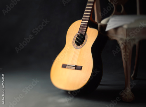 Classical Guitar leaning against chair with sheet music 