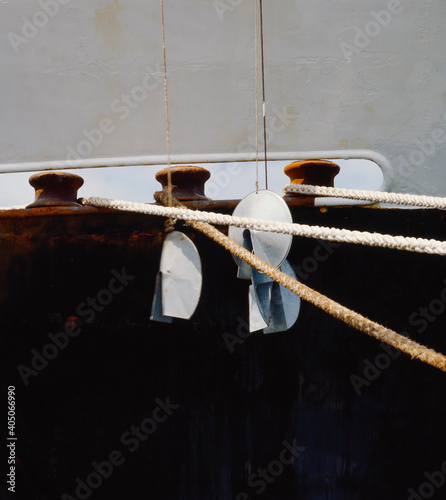 Ropes securing ship to mooring bollards on the wharf photo