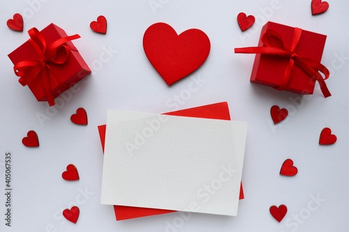 Valentine's day romantic composition. valentine's day background. red heart, figurines of white birds, gift box and place for text. red background. congratulation. invitation
