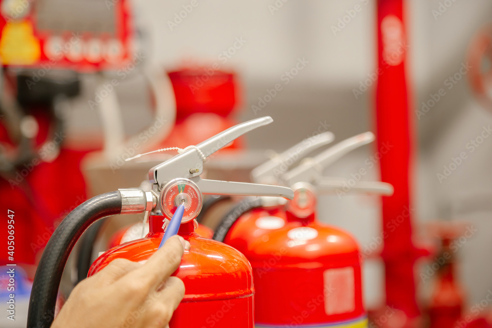 Engineer inspection Fire extinguisher and fire hose,Ready to use in the event of a fire.Safety first concept. Engineer inspection Fire extinguisher and fire hose,Ready to use in the event of a fire.Safety first concept.
