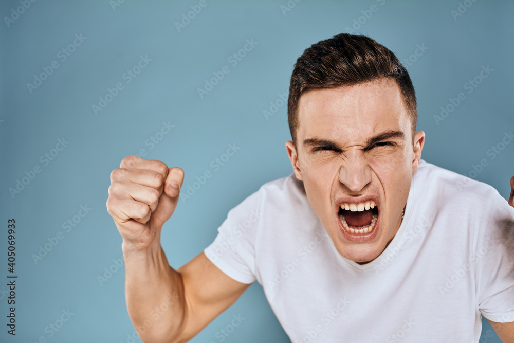 Man gestures with his hands emotions white t-shirt expression blue background Man gestures with his hands emotions white t-shirt expression blue background