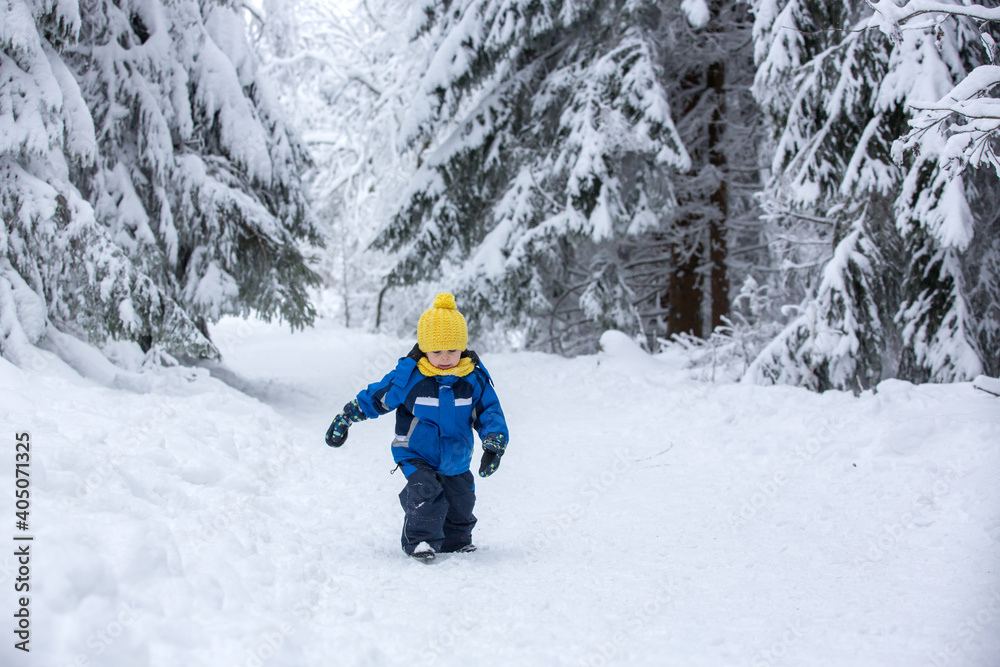 Sweet happy child, playing in deep snow