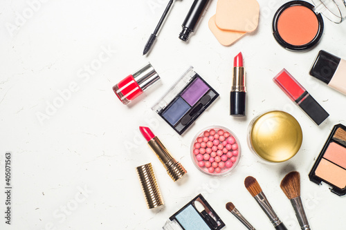 Makeup professional cosmetics, decorative cosmetic on white marble background. Flat lay image with copy space.