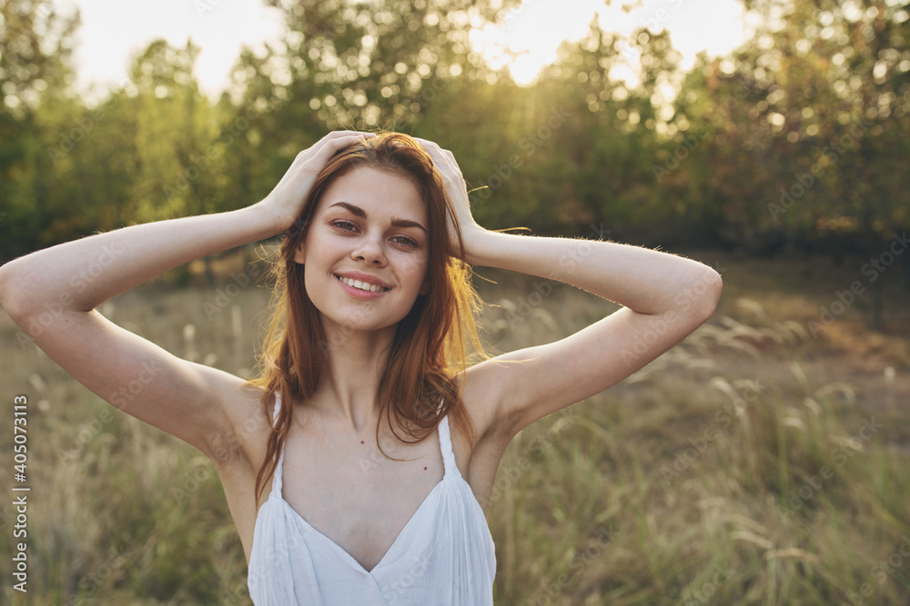 happily traveler resting in a field in nature and trees in the background gesturing with her hands happily traveler resting in a field in nature and trees in the background gesturing with her hands