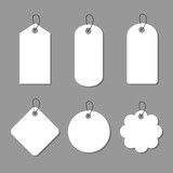Set of blank price tags in different shapes on grey background.