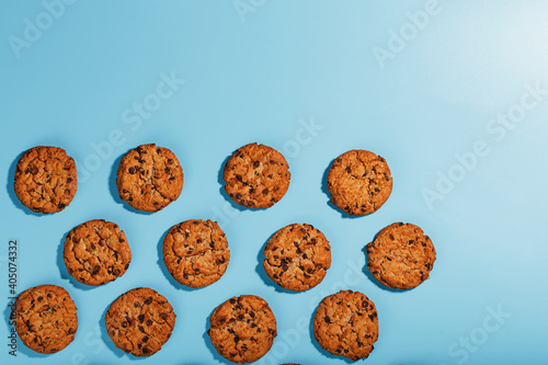Oatmeal cookies with chocolate chip pattern and patterns on a light blue background.