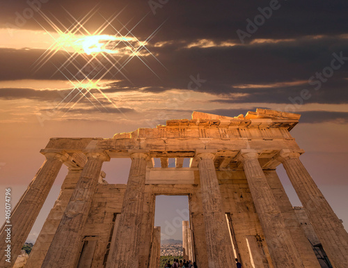 "Propylaea" the entrance of Acropolis illuminated by dramatic, fiery sunny sky, Athens Greece