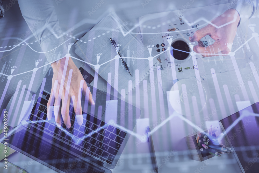 Multi exposure of man's hands typing over computer keyboard and forex graph hologram drawing. Top view. Financial markets concept. Multi exposure of man's hands typing over computer keyboard and forex graph hologram drawing. Top view. Financial markets concept.
