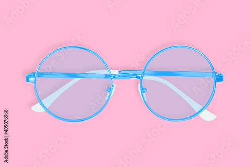 Glasses for improving vision with on a pink background.