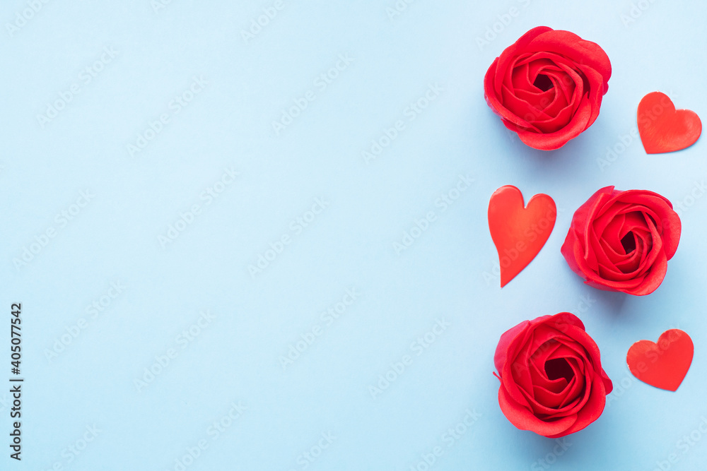 Handmade soap in the shape of a rose, red rose flower on a blue background. Top view, minimalist, copy space. Handmade soap in the shape of a rose, red rose flower on a blue background. Top view, minimalist, copy space.