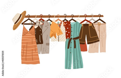 Stylish fashion clothes hanging on hangers on garment rack or rail isolated o...
