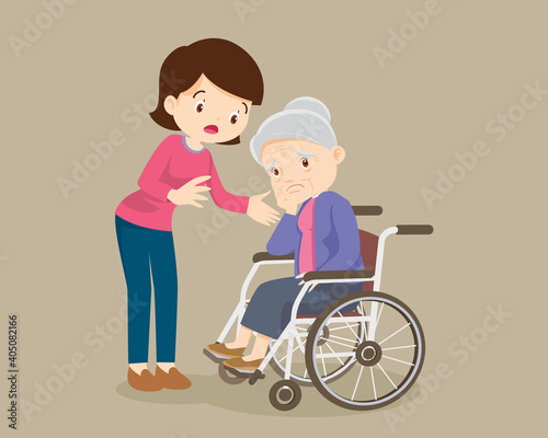 Woman soothes a grieving grandmother sitting on a wheelchair