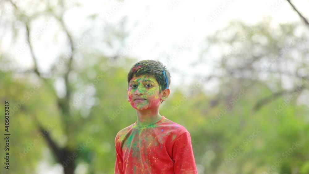 Holi festival : Indian child playing Holi in India. Holi is colors festival Holi festival : Indian child playing Holi in India. Holi is colors festival
